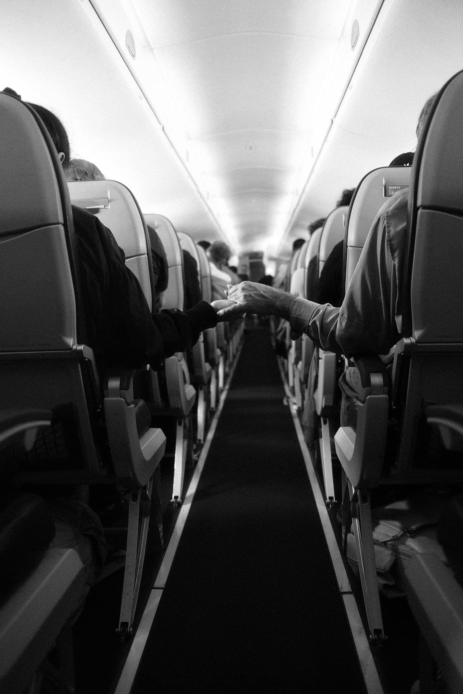 Empty cabin aisle, soft cabin lighting, no overhead bin chaos.
